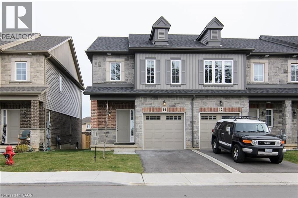 A black SUV is parked in front of a two-story house with a garage.