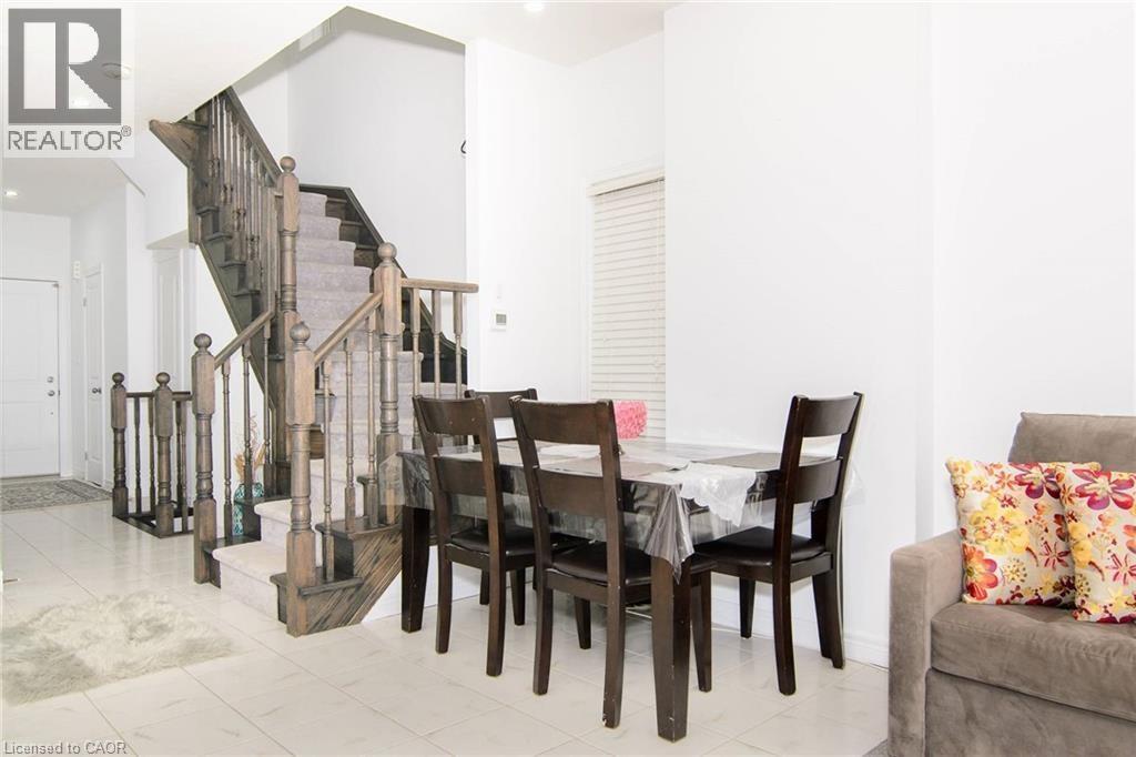 A dining room with a table set for four.