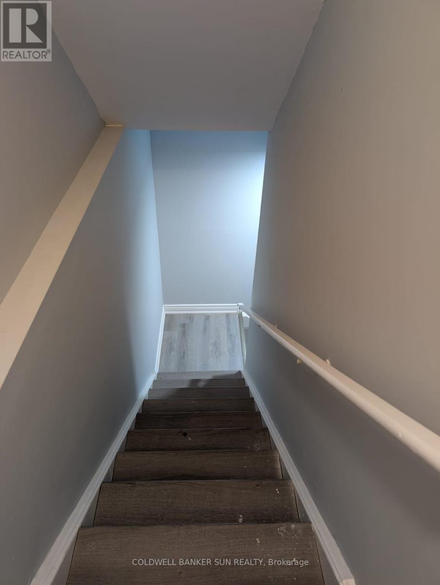 A stairway with a carpeted stairway and white walls.
