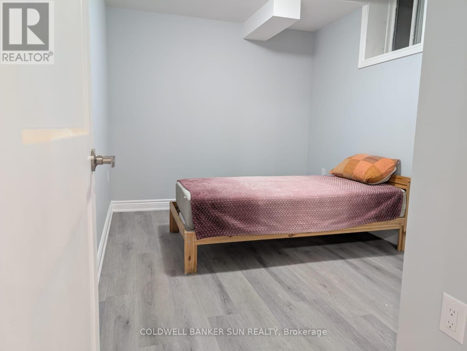 A bedroom with a bed and a pillow.