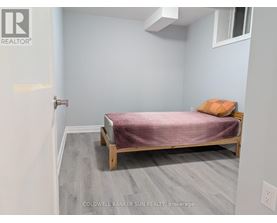 A bedroom with a bed and a pillow.