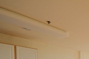 open layout living room that is attached to kitchen; white walls and hardwood floors - Photo Gallery 2