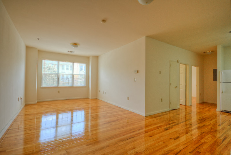 living room with hardwood floors, white walls and 3 panel windows