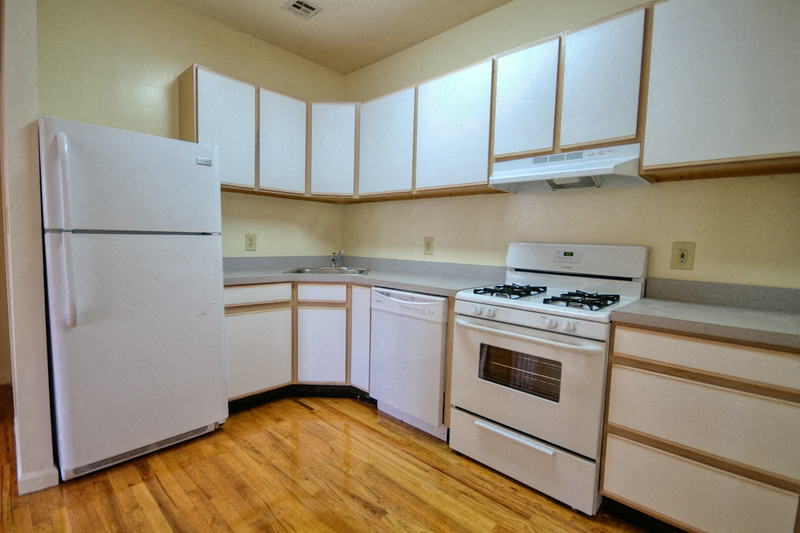 kitchen with white appliances and white &wooden cabinets