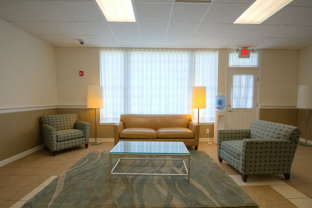 a living room with couches and chairs and a table