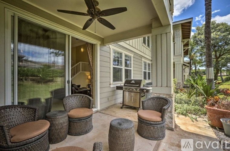 A patio with a table, chairs, and a ceiling fan.
