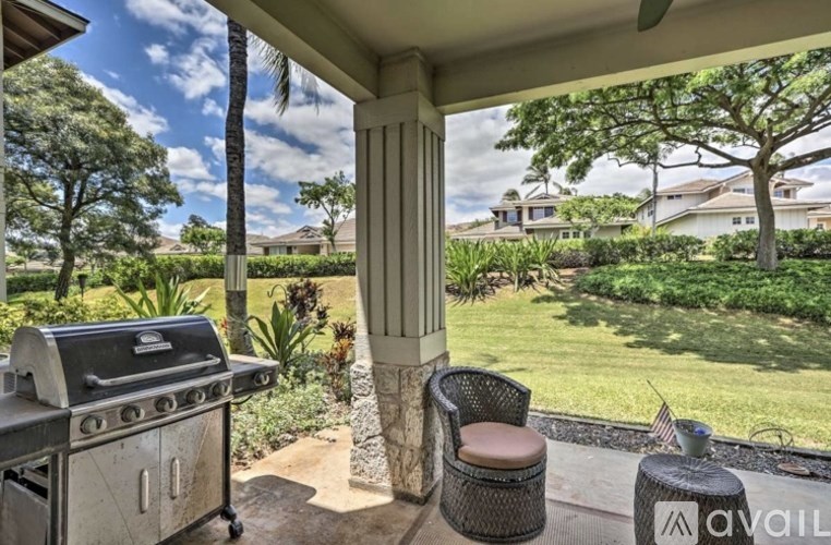 A patio with a grill and a chair is available for rent.