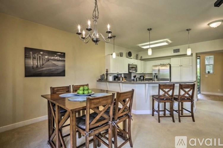 A dining room with a wooden table and chairs.