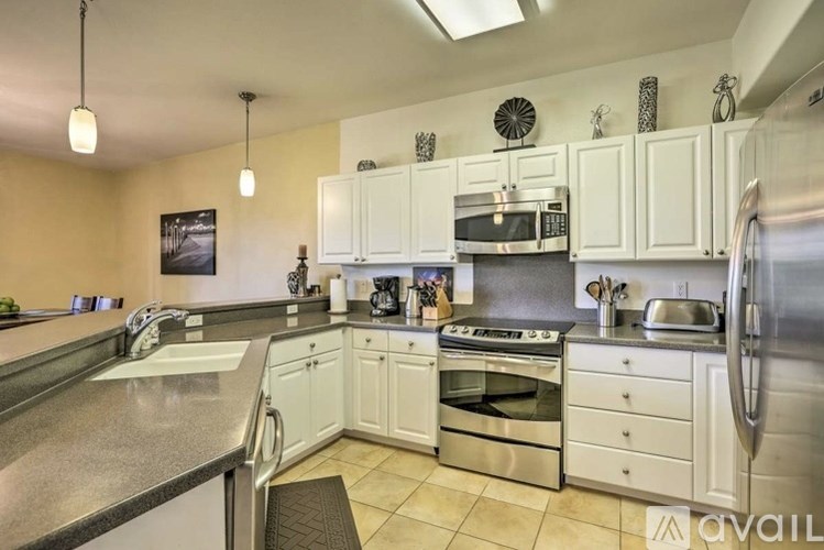 A kitchen with white cabinets and stainless steel appliances.