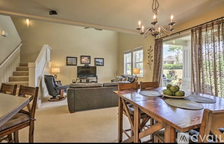 A dining room with a wooden table set for a meal.