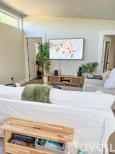 A living room with a white couch and a wooden coffee table.