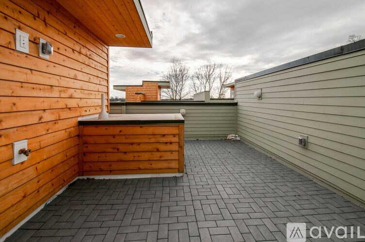 A wooden deck with a tiled floor and a wooden wall.