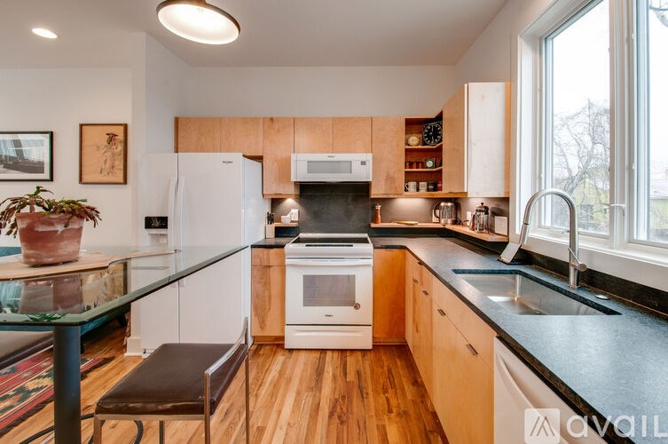 A kitchen with wooden cabinets and a black countertop.