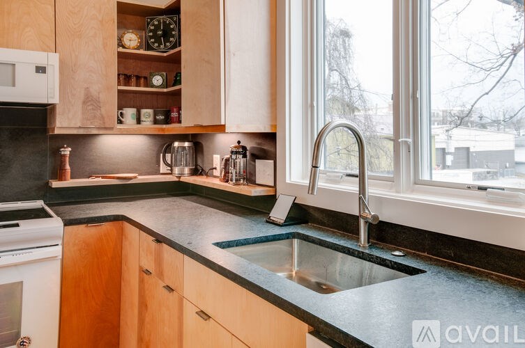 A kitchen with a sink and a window.