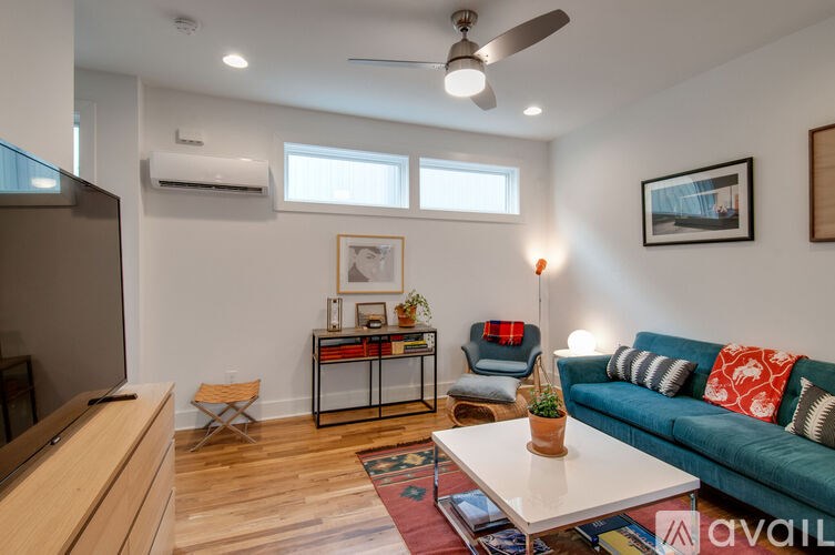 A living room with a blue couch and a coffee table.