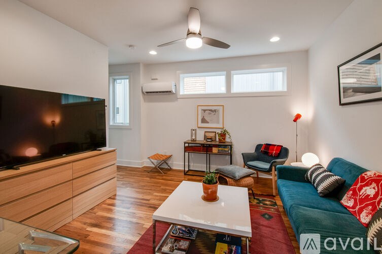 A living room with a television, a sofa, and a coffee table.