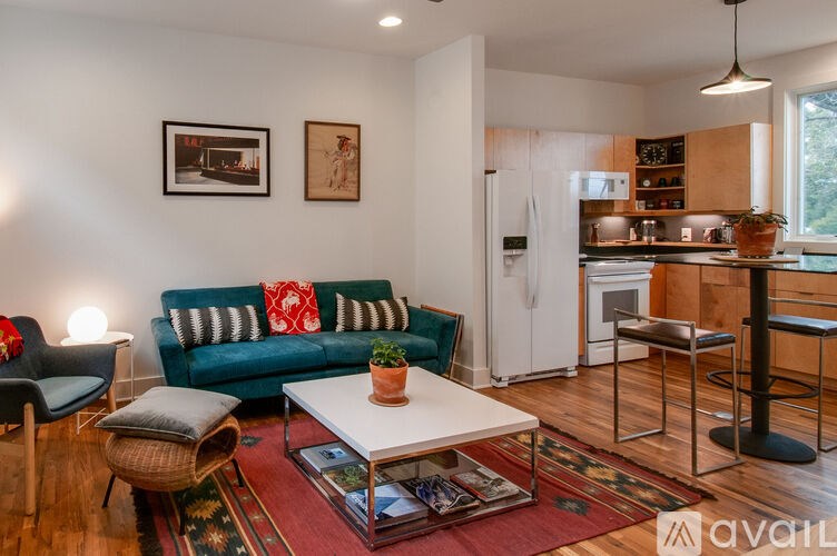A living room with a blue couch and a white coffee table.