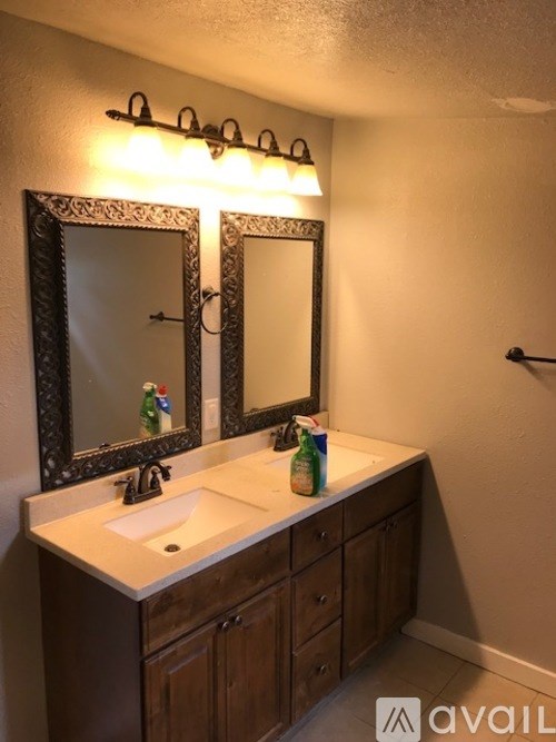 A bathroom with a sink and mirror.
