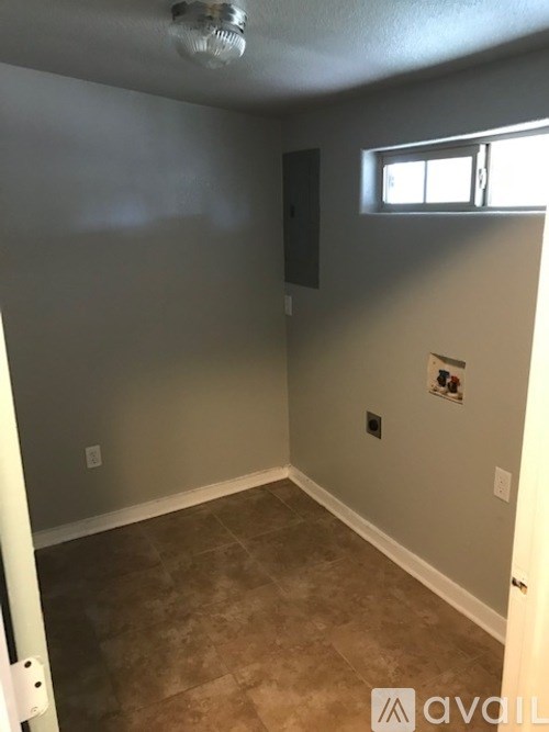 A room with a window and a ceiling fan.
