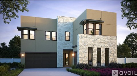 A modern house with a stone facade and a large garage door.
