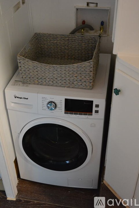 A white Magic Chef washing machine with a basket on top.