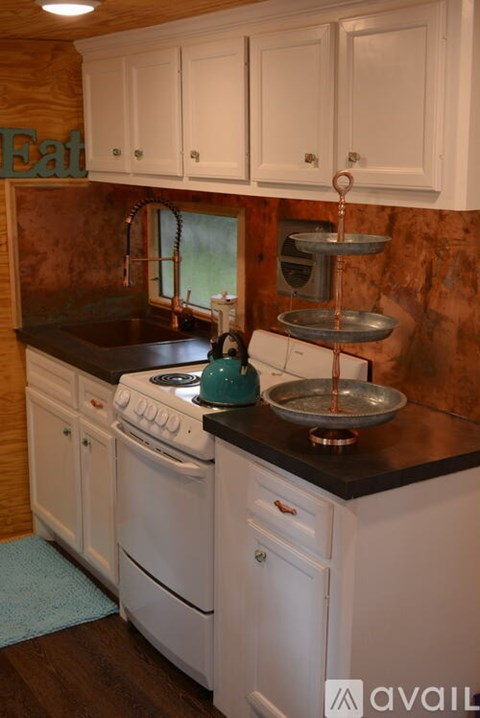 A kitchen with a white oven and black countertop.
