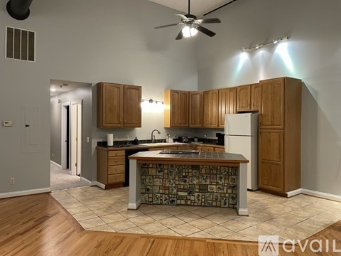 A kitchen with wooden cabinets and a patterned island.