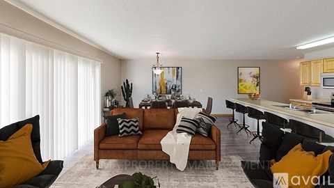 A living room with a brown couch and a coffee table.