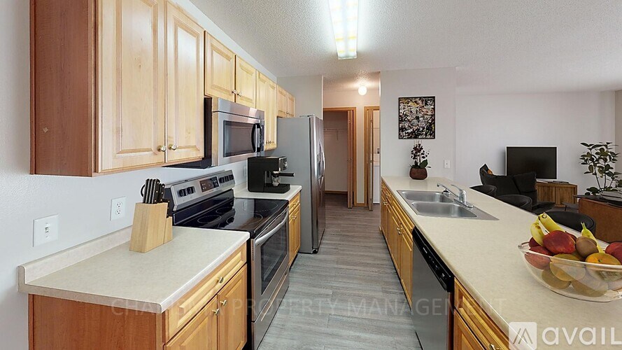 A kitchen with wooden cabinets and a white countertop.