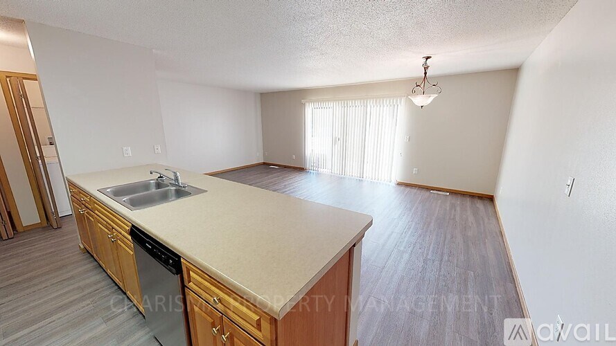 A kitchen with wooden cabinets and a beige countertop.