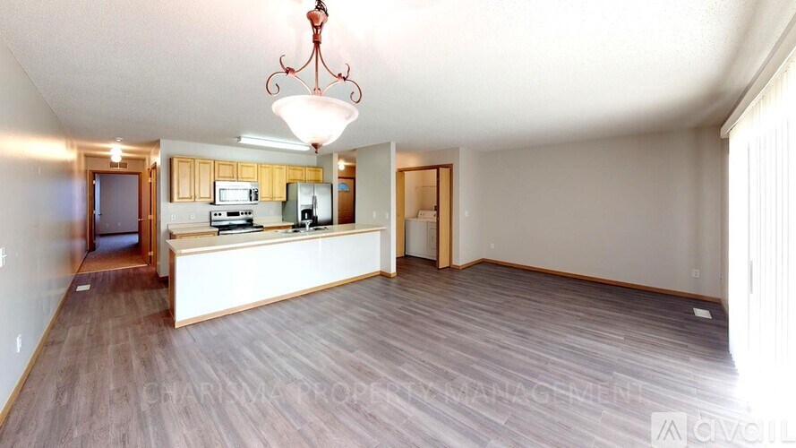 A large open room with a kitchen area and a dining table.