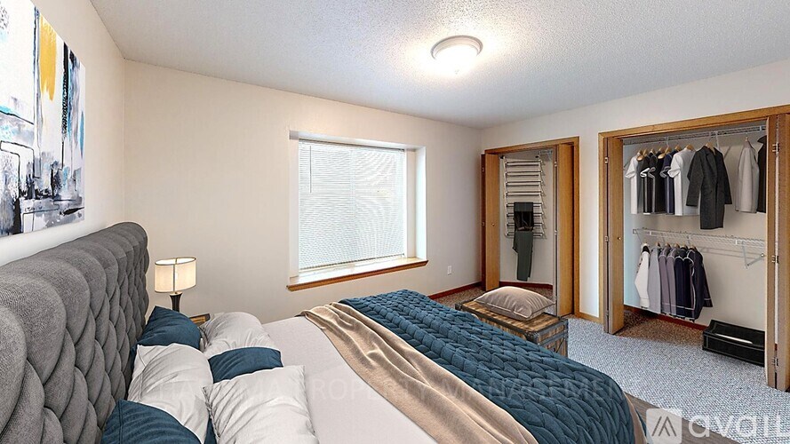 A bedroom with a bed, a mirror, and a wardrobe.