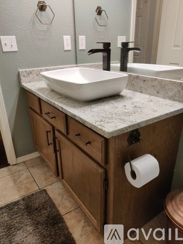 A bathroom with a sink and a mirror.