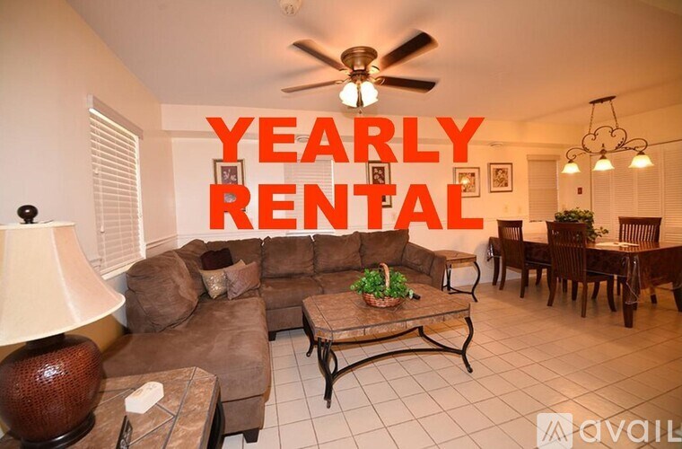 A living room with a couch, chairs, and a ceiling fan, with the words "Yearly Rental" prominently displayed.