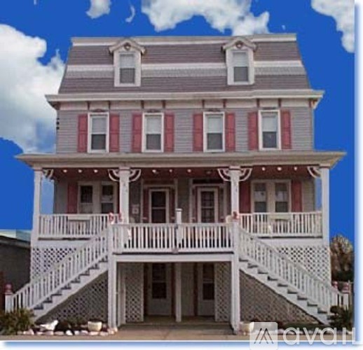 A two-story house with a porch and a balcony.