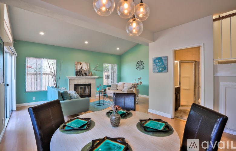 A dining room with a white table and chairs.