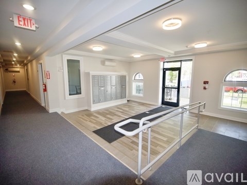 A spacious room with a wheelchair-accessible ramp leading to a door.