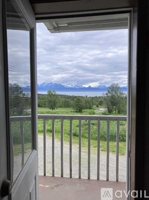 A view from a balcony looking out at a landscape with mountains in the distance.