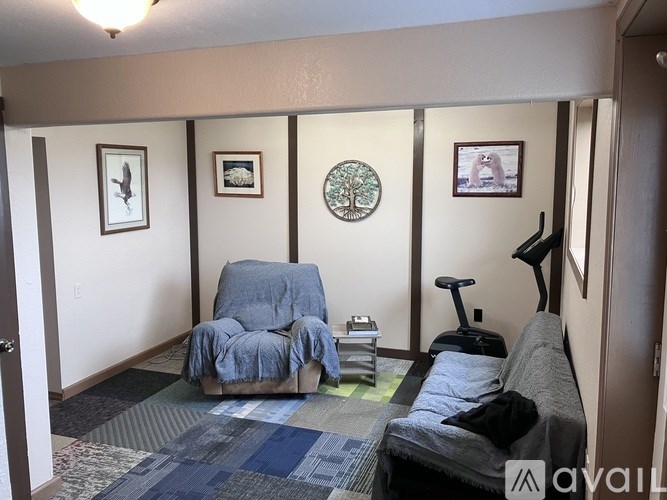 A living room with a grey couch and a blue chair.
