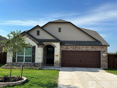 A two-story house with a garage and a driveway.
