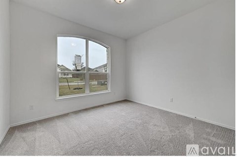 A room with a large window and carpeted floor.