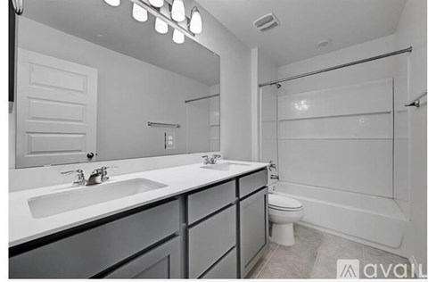 A bathroom with a white sink, toilet, and bathtub.