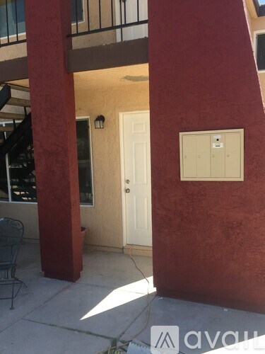 A white door is on the right side of a red column.