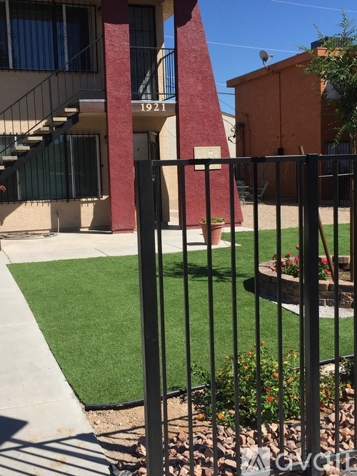 A red and white pillar stands in front of a building with the number 1921 on it.
