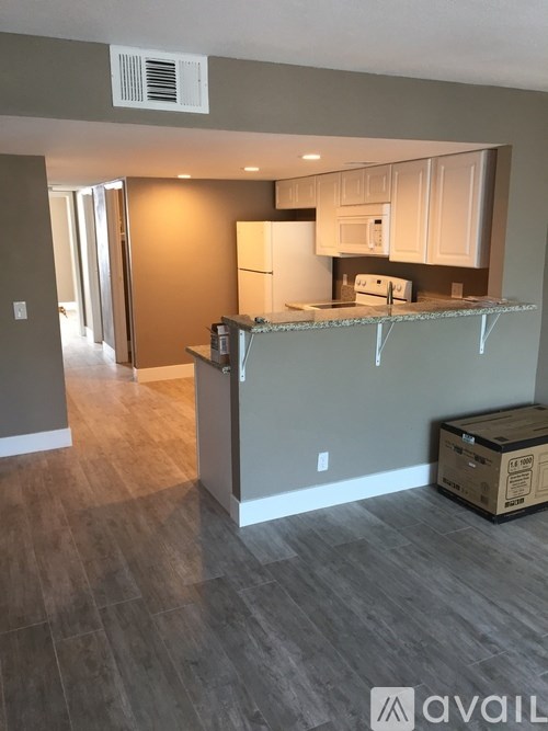 A kitchen area with a box on the floor.