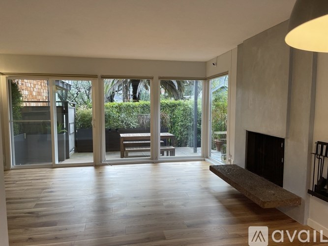 A spacious living room with a fireplace and sliding glass doors.