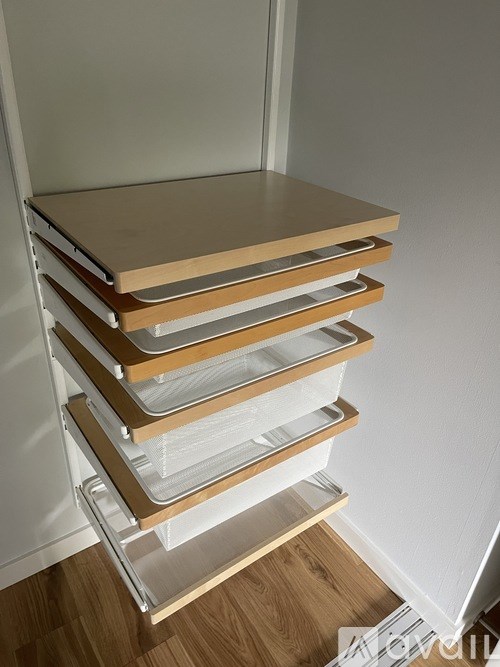 A stack of plastic drawers with wooden lids.