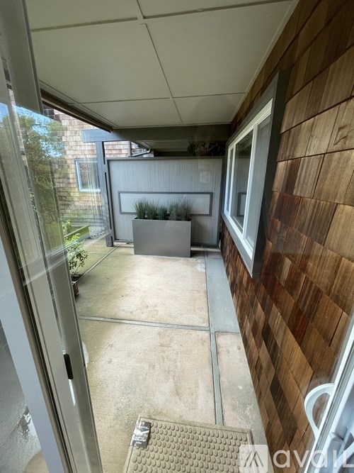 A patio area with a table and chairs is visible from the doorway.