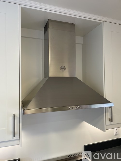 A stainless steel range hood in a kitchen.