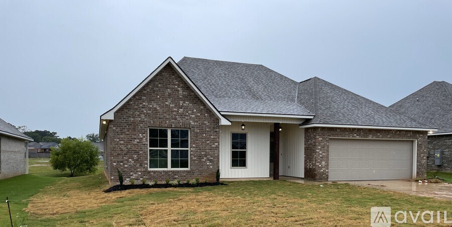 A house with a white door and a grey garage door.